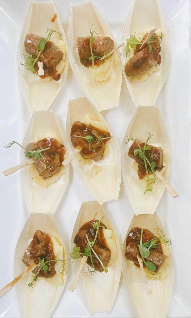 Delicious mini beef tacos served on bamboo boats, featuring tender meat, fresh greens, and flavorful sauces. Ideal for events.