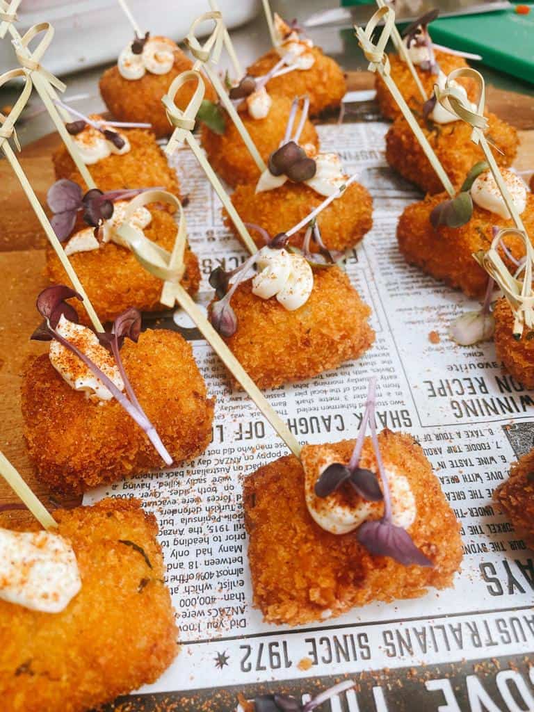 Delectable fried meat bites garnished with microgreens, perfect for appetizers or party snacks at Meat Mechanics.