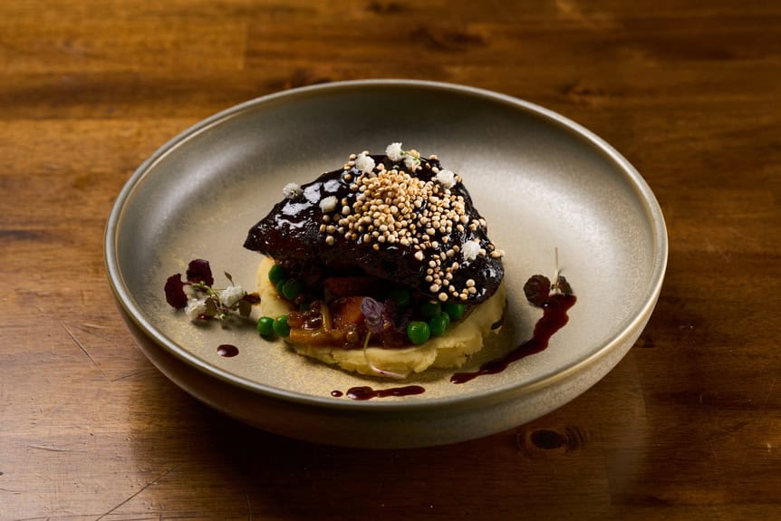Delicious meat dish featuring perfectly cooked beef with gourmet garnishes.